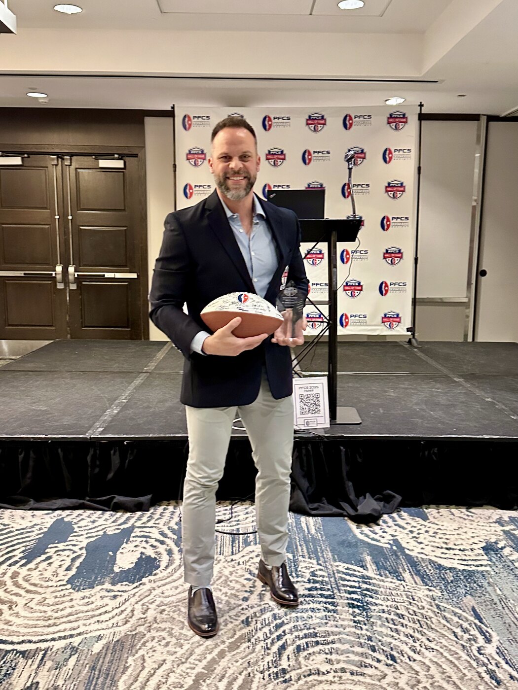 Dr. Joe Krzemien holding the PFCS Hall of Fame trophy
